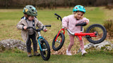 3 year old girl lifting littlebig lightweight balance bike