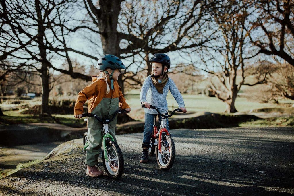 girl and boy on littlebig balance bike and pedal bike 2022
